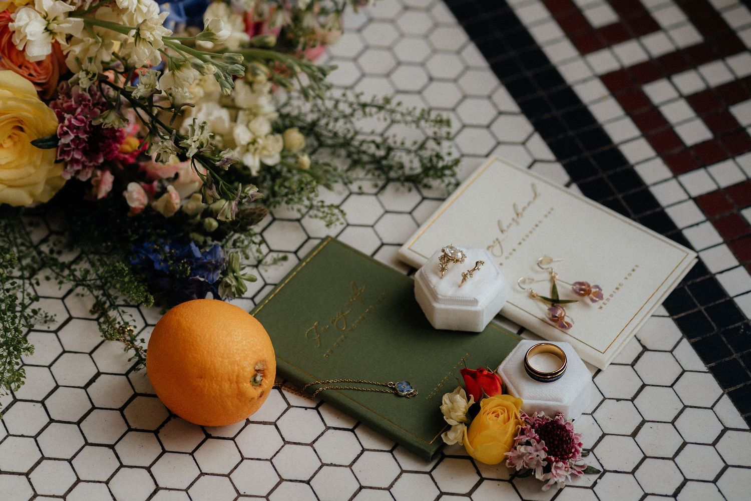 White and black checkered tile backsplash with orange pumpkins and floral arrangements creating a cozy fall display.