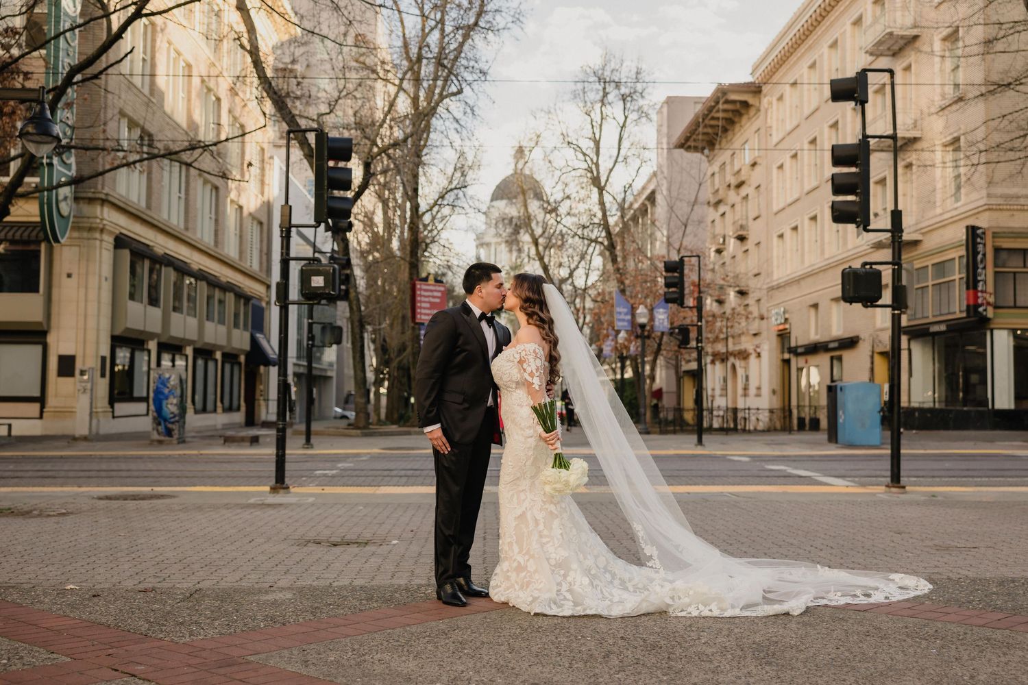 A collection of romantic wedding photos showing couples along a European-style city street with grand architecture.