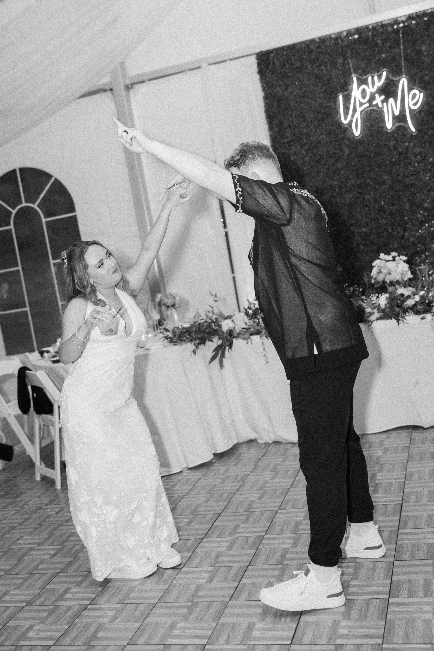 Dancing sequence shows a bride and groom performing a playful dip move during their wedding reception first dance.