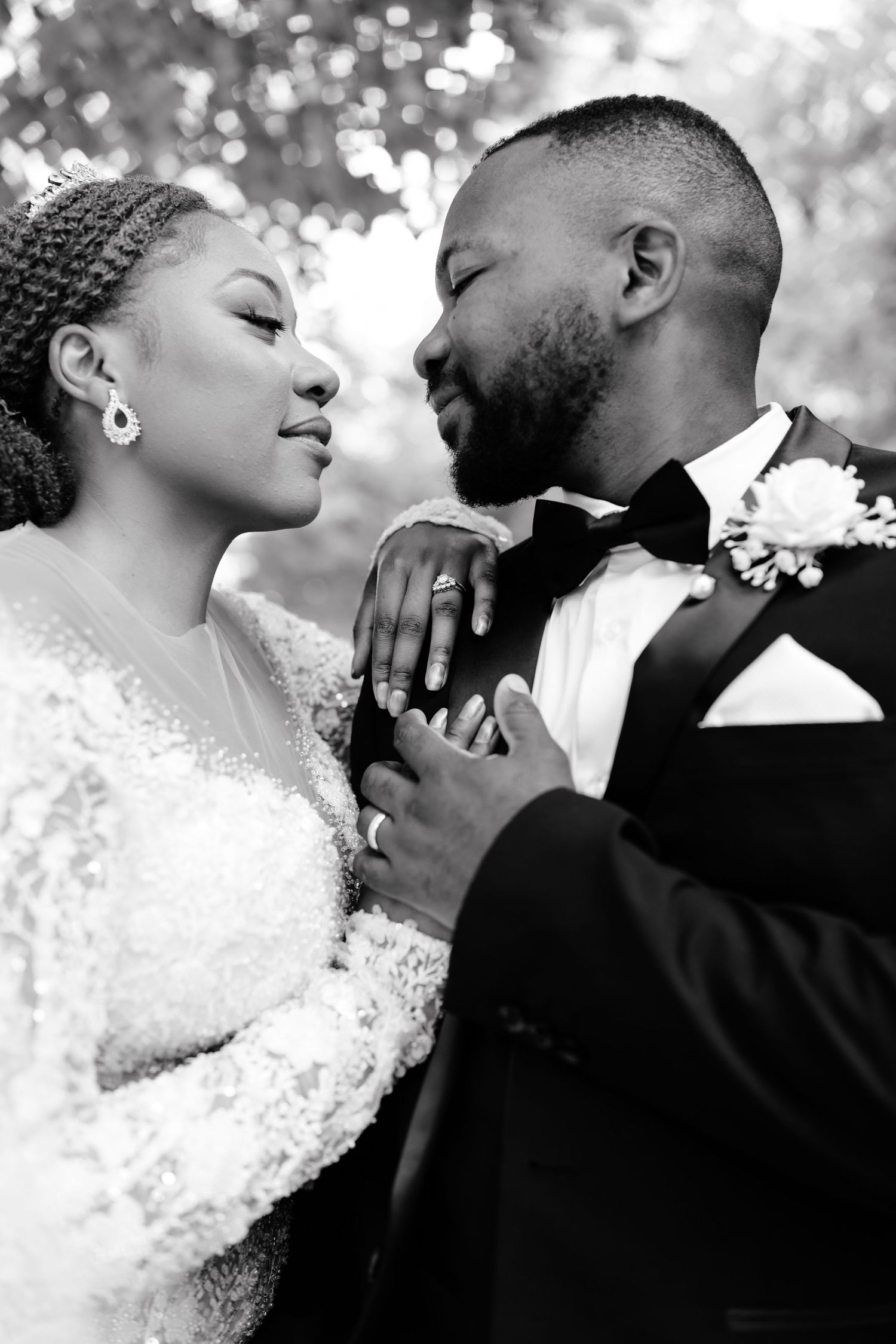 A romantic black and white photo series showing tender moments between a bride and groom on their wedding day.