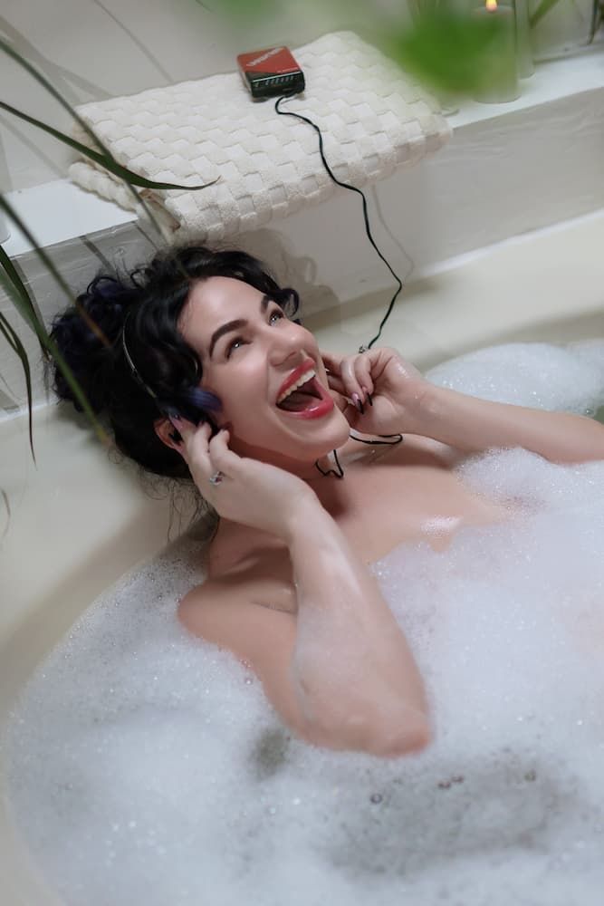 A relaxing bubble bath scene with someone enjoying a luxurious soak in a white bathtub.