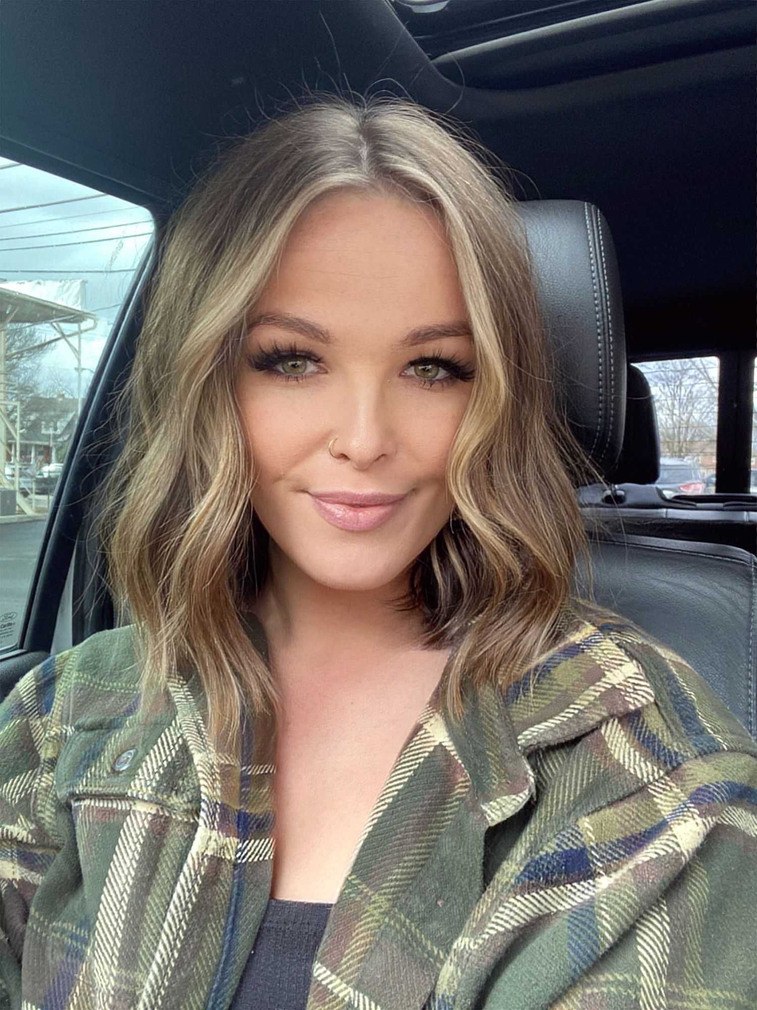 A series of selfies taken in a car showing someone wearing a camouflage print jacket.