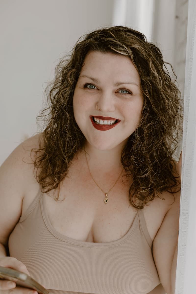 A series of four similar portrait photos showing someone with curly brown hair wearing a beige tank top.
