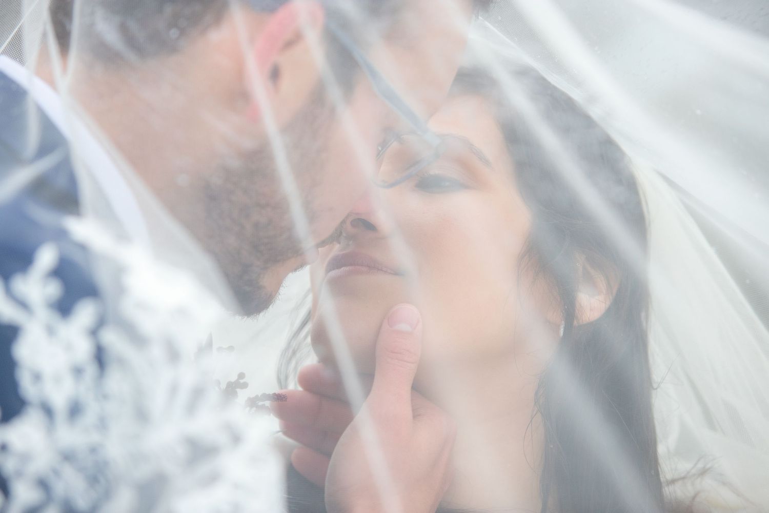 Bridal portrait of a bride under her veil embracing her groom, photographed by Cedar Park Photographer Pamela Clark of Perfectly Imperfect