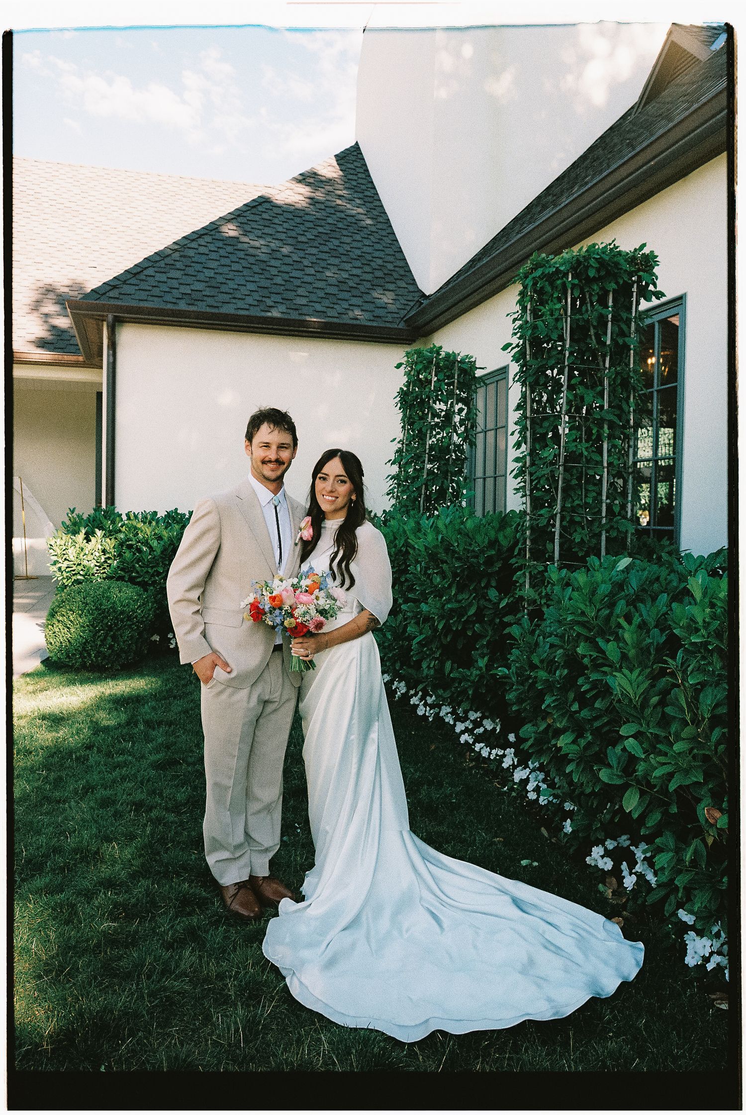 Bride and groom portrait photographed on film outside a Utah wedding venue.