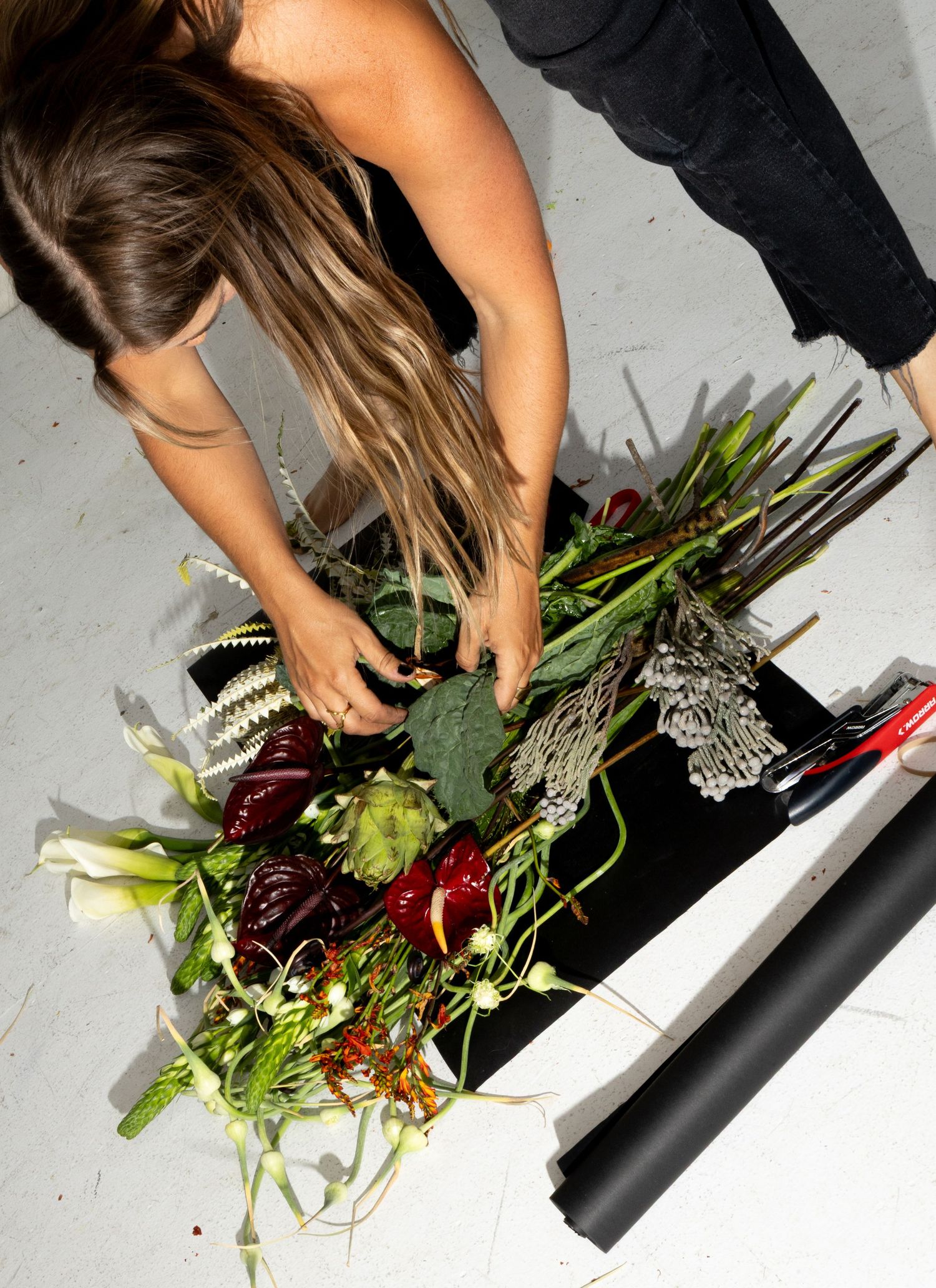 Behind-the-scenes brand photograph of a florist arranging flowers in Salt Lake City, Utah.