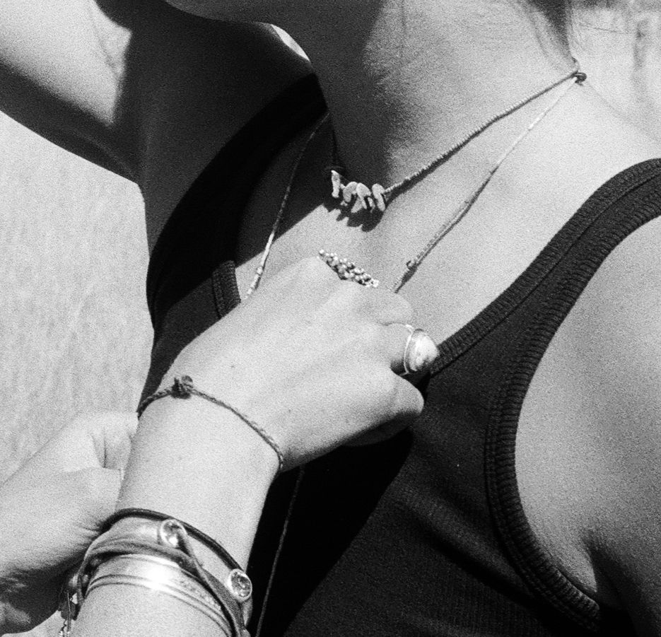 Black and white film detail of handmade jewelry being worn in Midway, Utah.