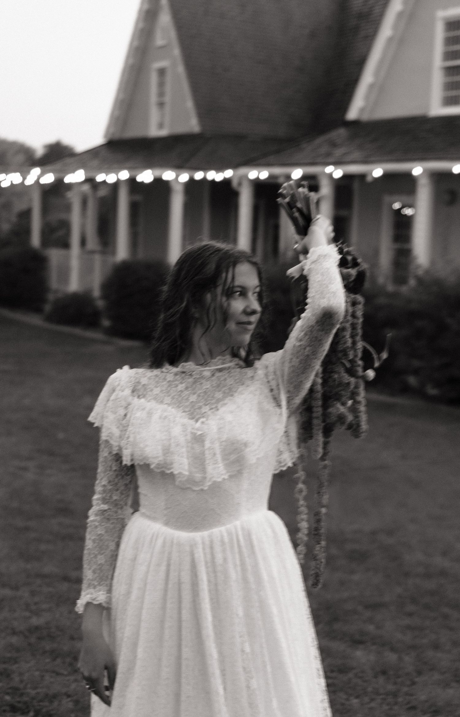 Candid black and white photo of a bride celebrating at her Utah wedding.