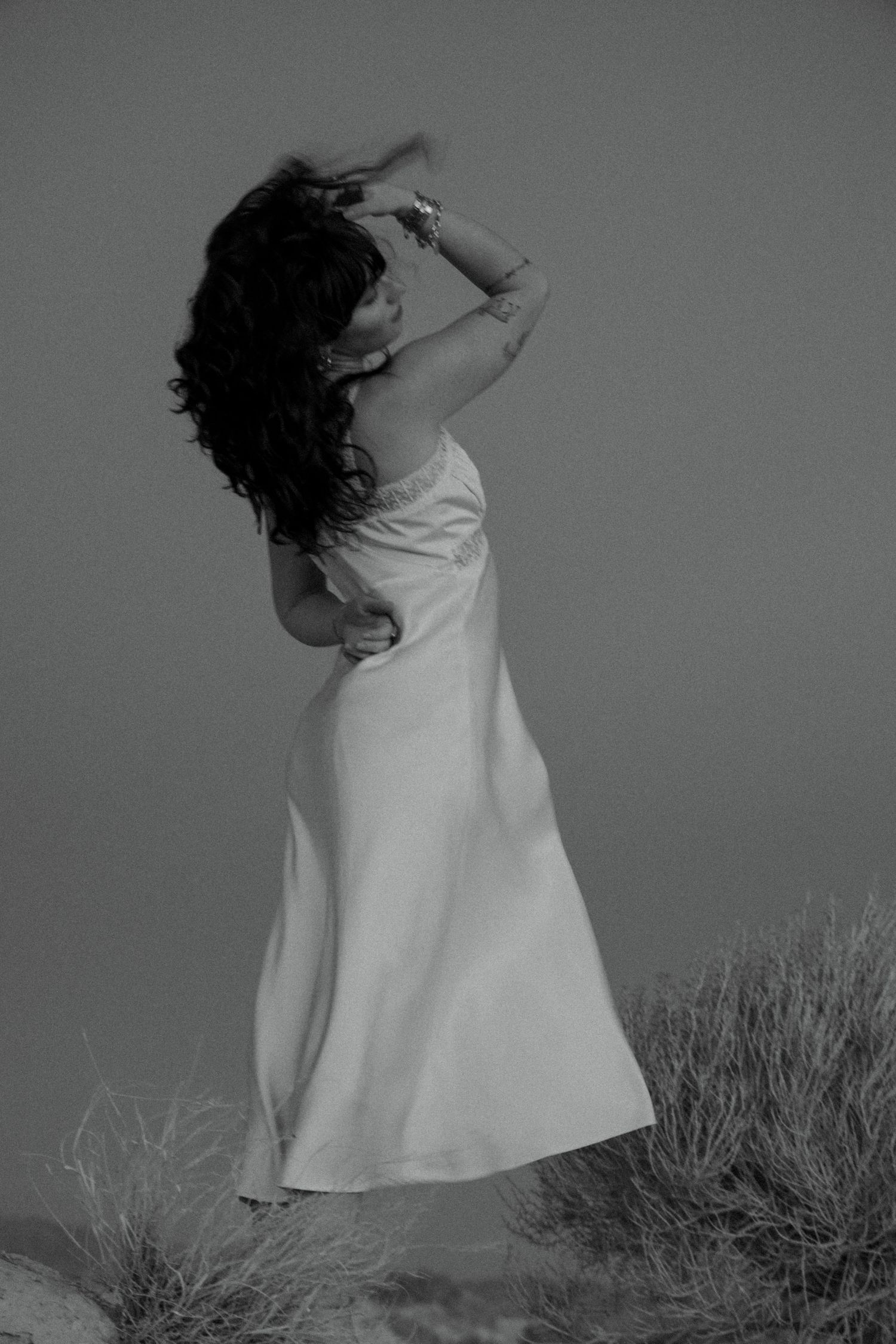 Black and white creative bridal portrait in a flowing dress in the Utah landscape.