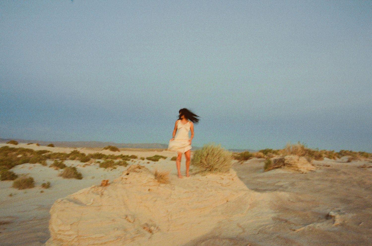 35mm film portrait of a woman exploring a desert landscape in Utah.