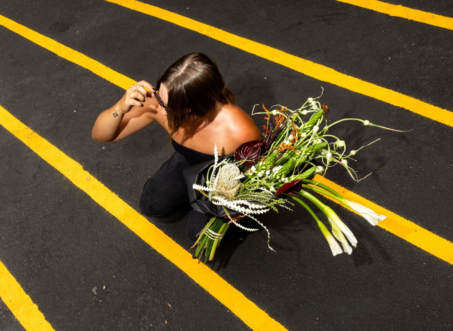 Creative brand photography of a florist holding an artistic bouquet in Salt Lake City, Utah.