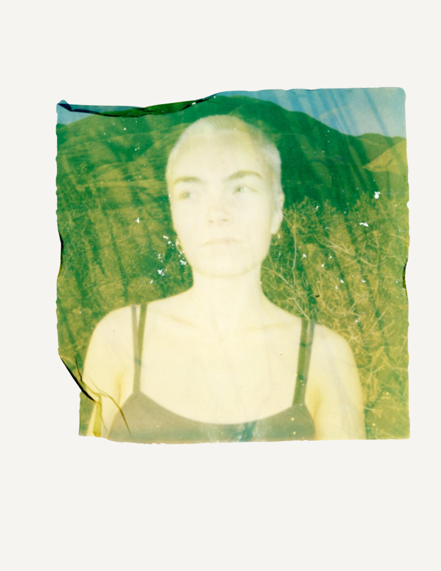 Experimental Polaroid emulsion lift portrait with green tones and handmade texture.