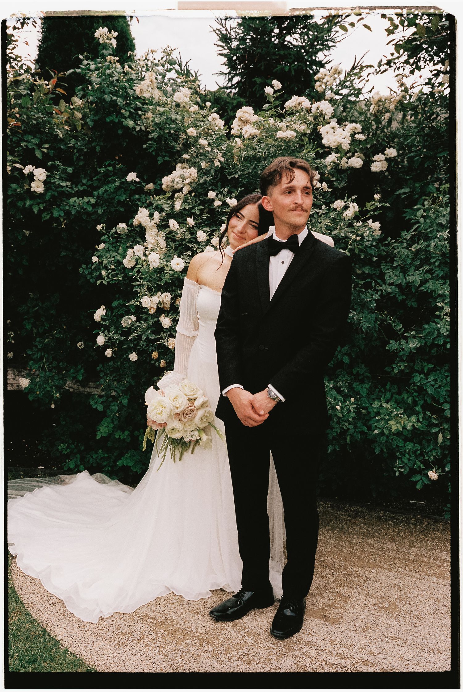 Bride and groom portrait in a garden photographed on film at a Utah wedding.