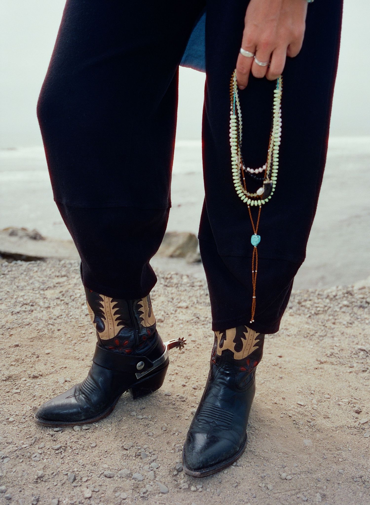 120 film detail portrait featuring handmade jewelry and western boots in California.