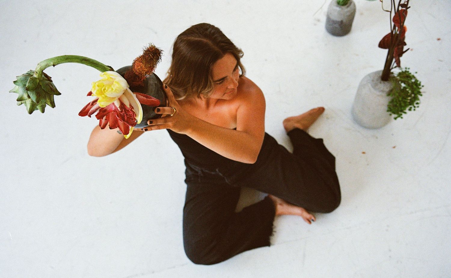 Creative 35mm film portrait of a florist arranging flowers in Salt Lake City, Utah.