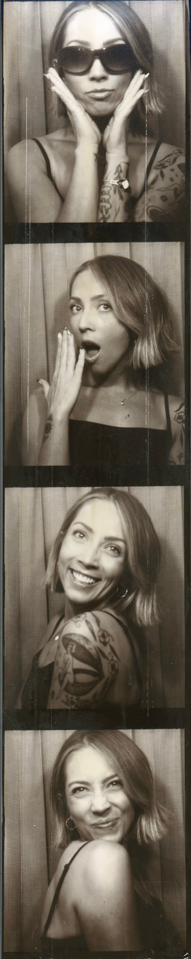 Black and white photo booth strip featuring four candid portrait photographs.