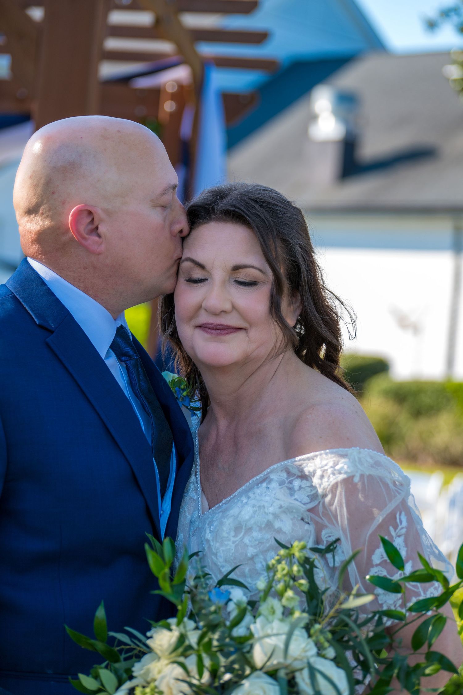 Bride and Groom share an intimate moment during their formal photos at DeerCreek Country Club.