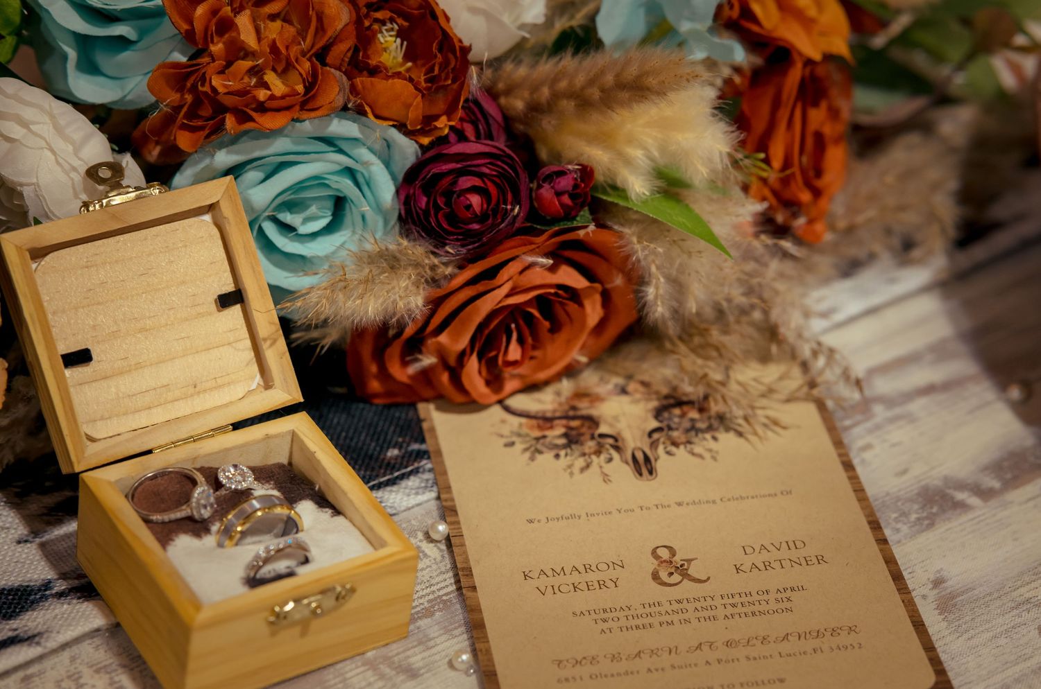 Flat Lay of invitation, rings and bouquet
