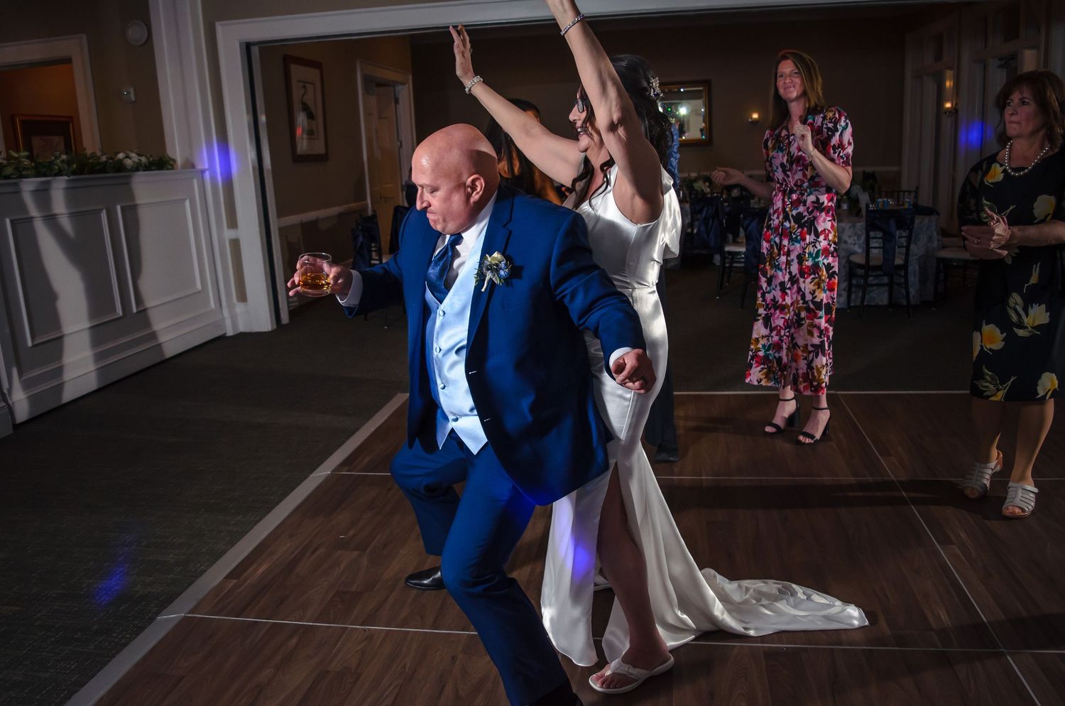 Bride and Groom having fun dancing with guests at their reception.