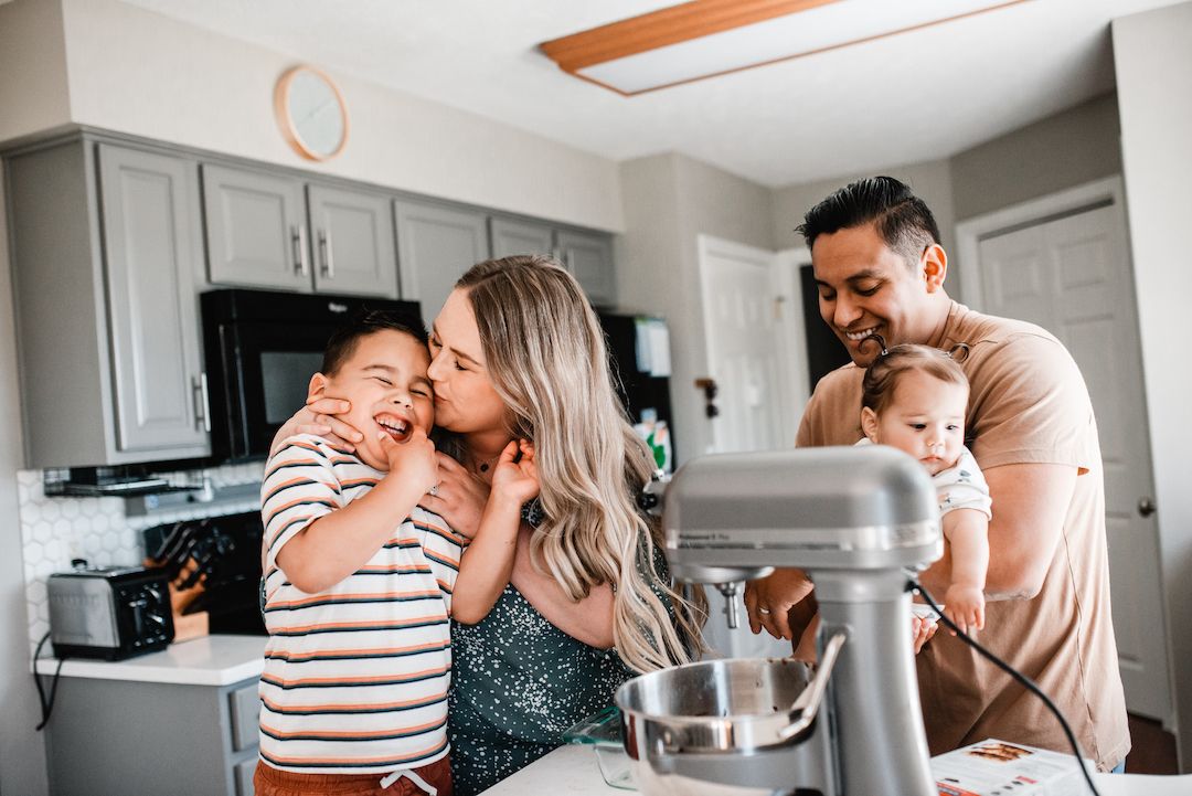 Family playing and laughing during an in-home photo session with Melissa Lindquist Photography in Omaha.
