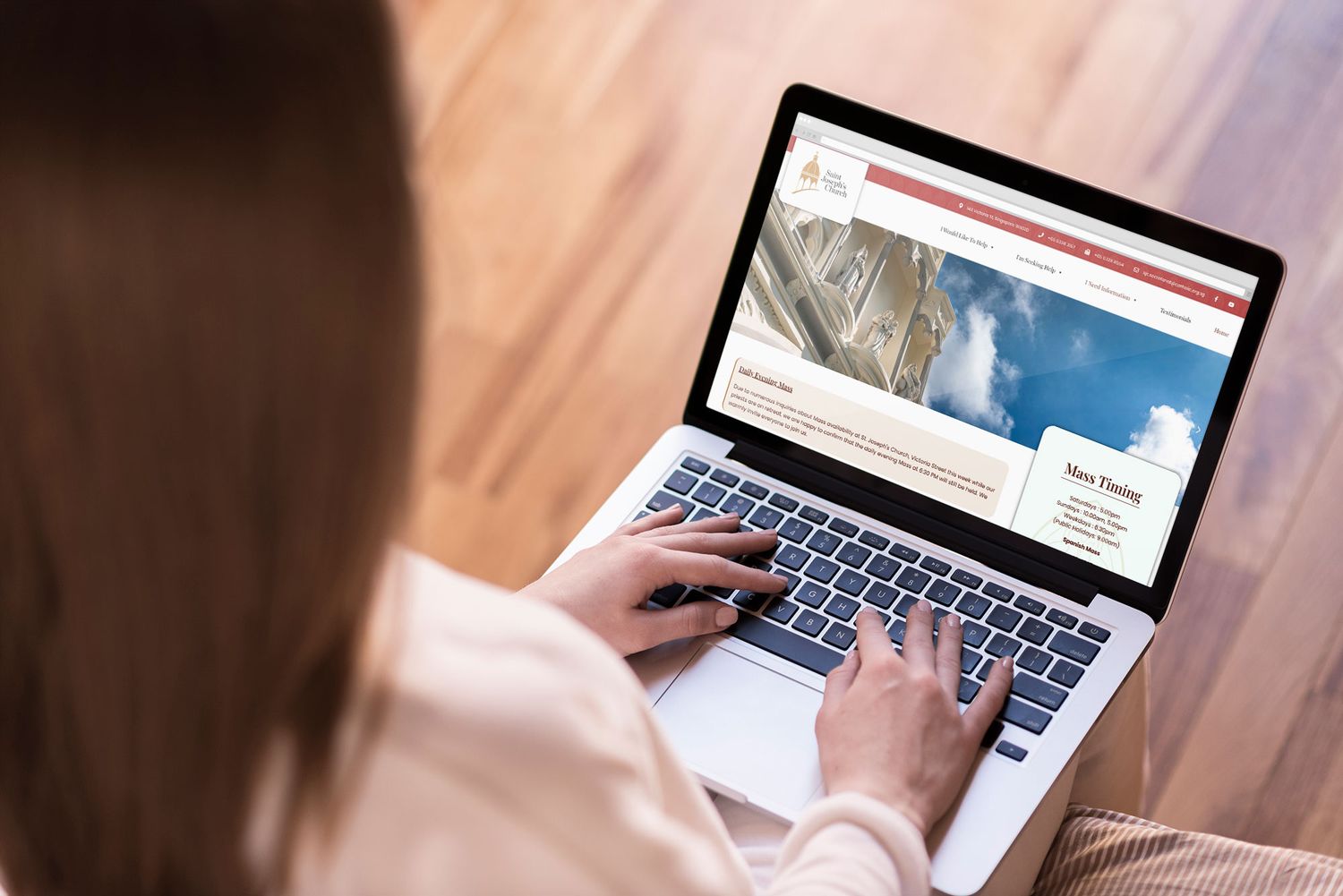 Person typing on laptop keyboard while browsing travel website homepage.