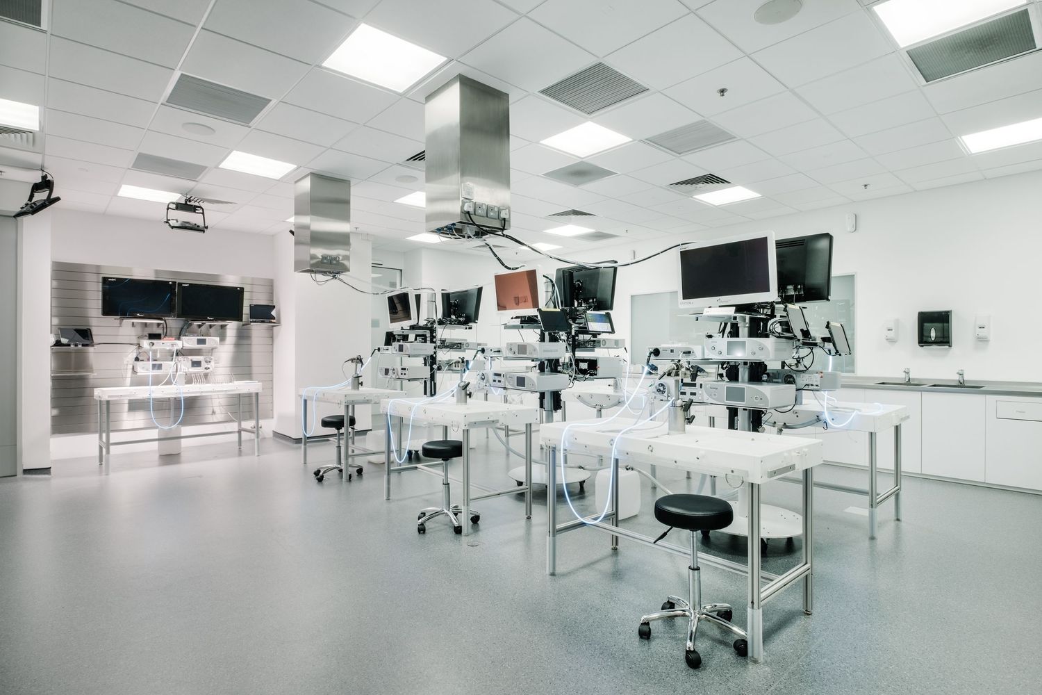 Clean, bright laboratory space with workstations and equipment arranged in neat rows.