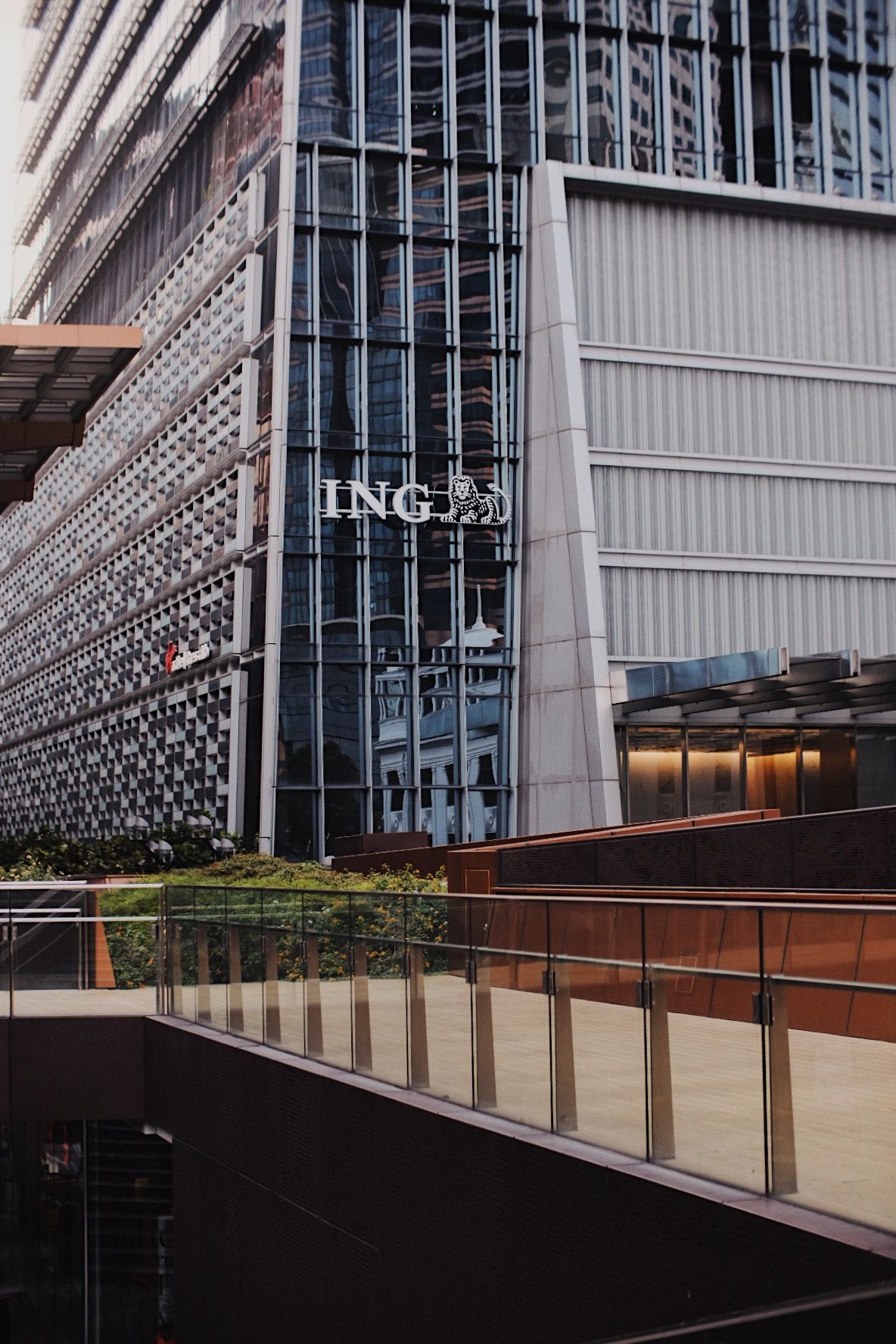 Contemporary architectural detail of glass and metal building facade with geometric patterns.