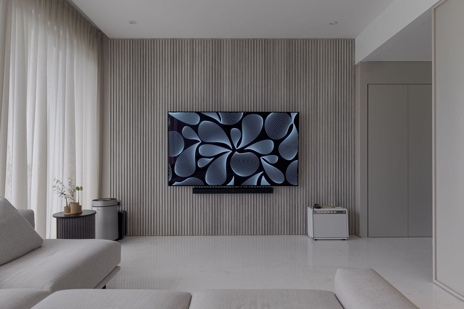 Contemporary living space with textured walls and geometric art installation.