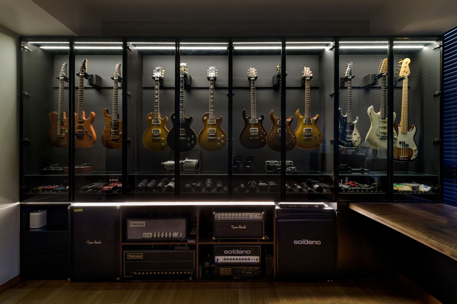 Display cases showcase a collection of vintage guitars and musical instruments in a museum setting.