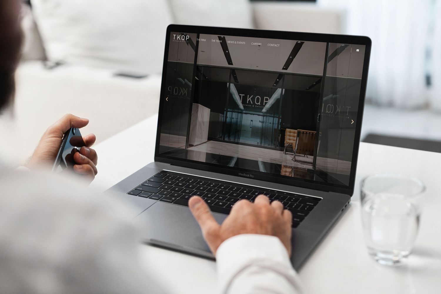 Multiple laptop and mobile device screens displaying a business website interface.
