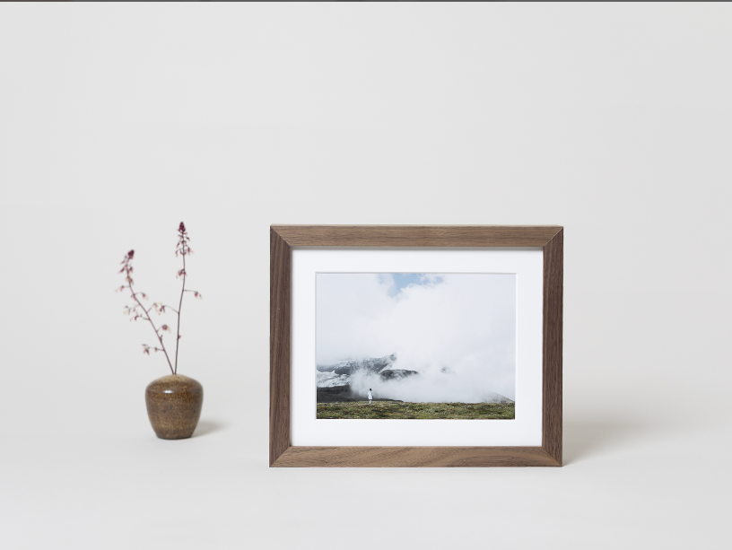 Brown frame with white mat.