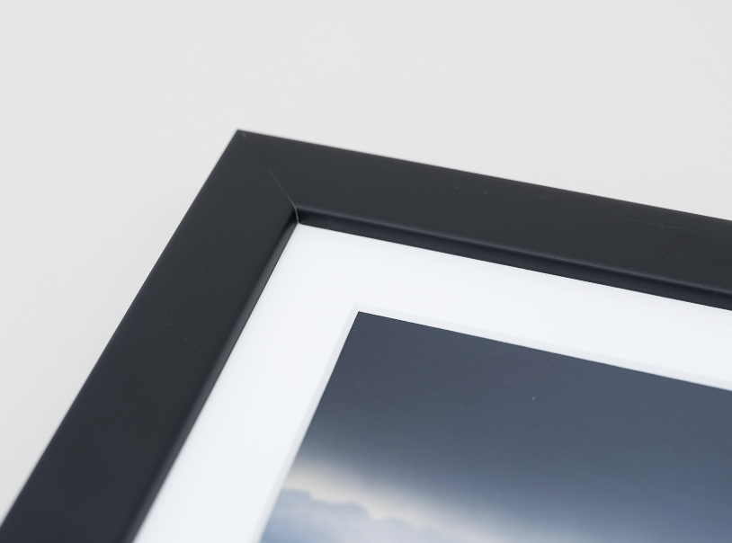Close up of black frame to show size of frame and white mat.