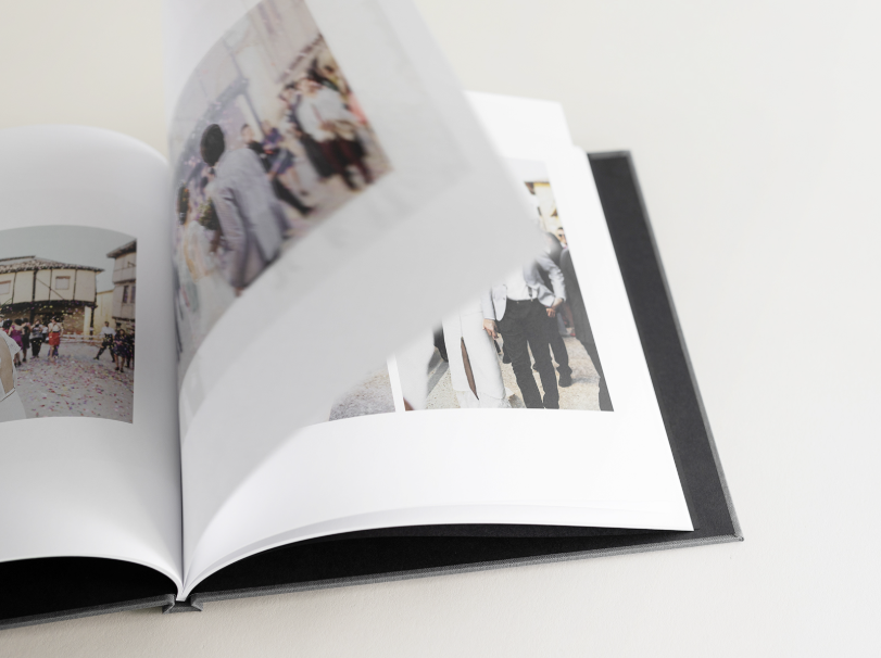 Flipping pages of a hardcover book showcases page flexibility. Pages do NOT lay flat against covers.