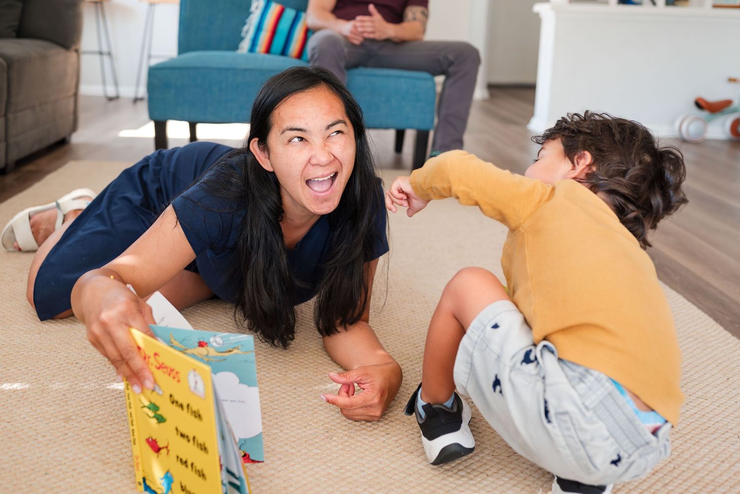 Mother and son reading together on the floor at home