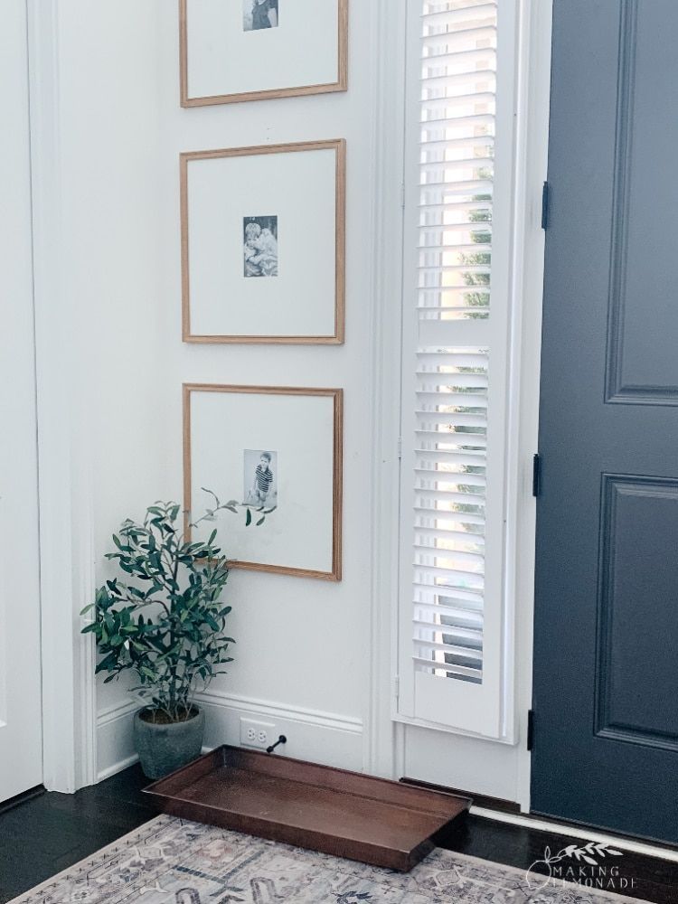 Vertical gallery wall in entryway next to front door. Doughman Photography.