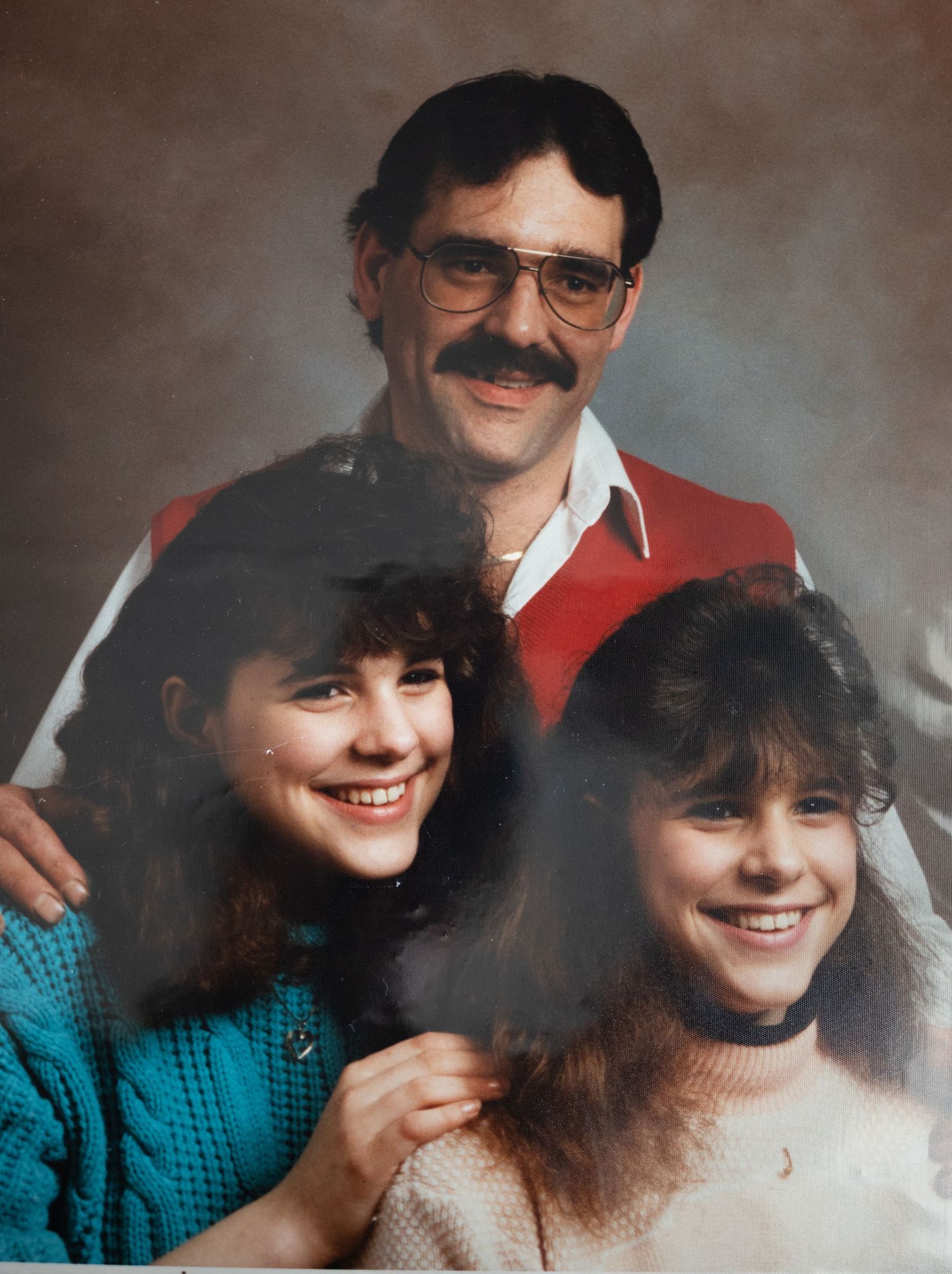 Classic portrait image of photographer as a teenager with her sister and father. About Me. Doughman Photography.