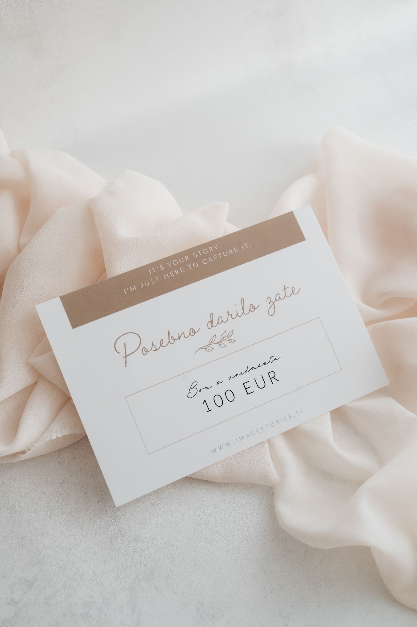 Elegant minimalist name place cards with calligraphy text displayed with flowing blush silk ribbon on light background.