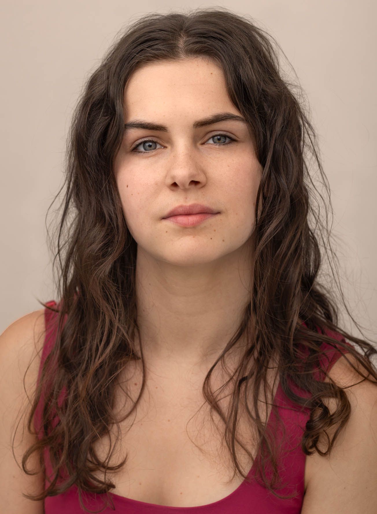 Young woman in red/pink top:
Actor headshot of a young woman photographed at Abigail Stewart Photography studio in Buckinghamshire