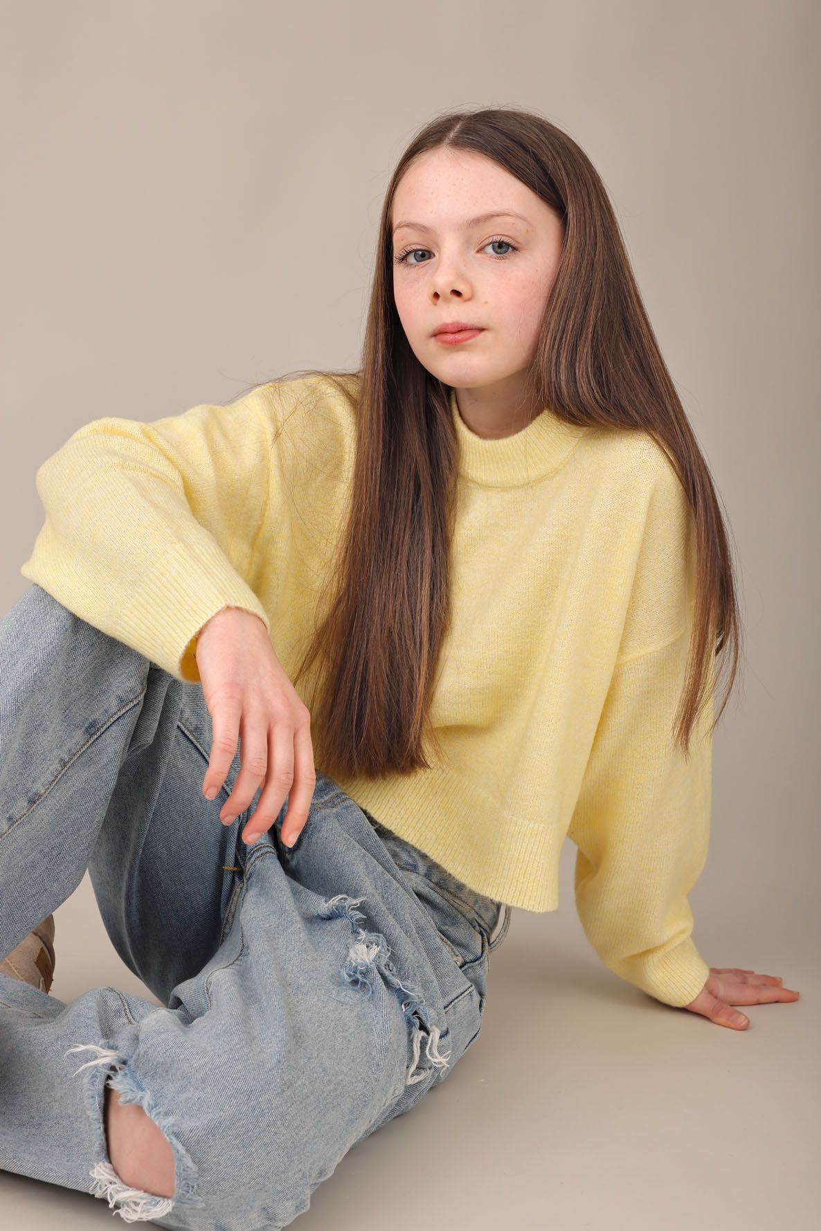Young girl in yellow top, seated:
Actor headshot of a young woman photographed at Abigail Stewart Photography studio in Buckinghamshire