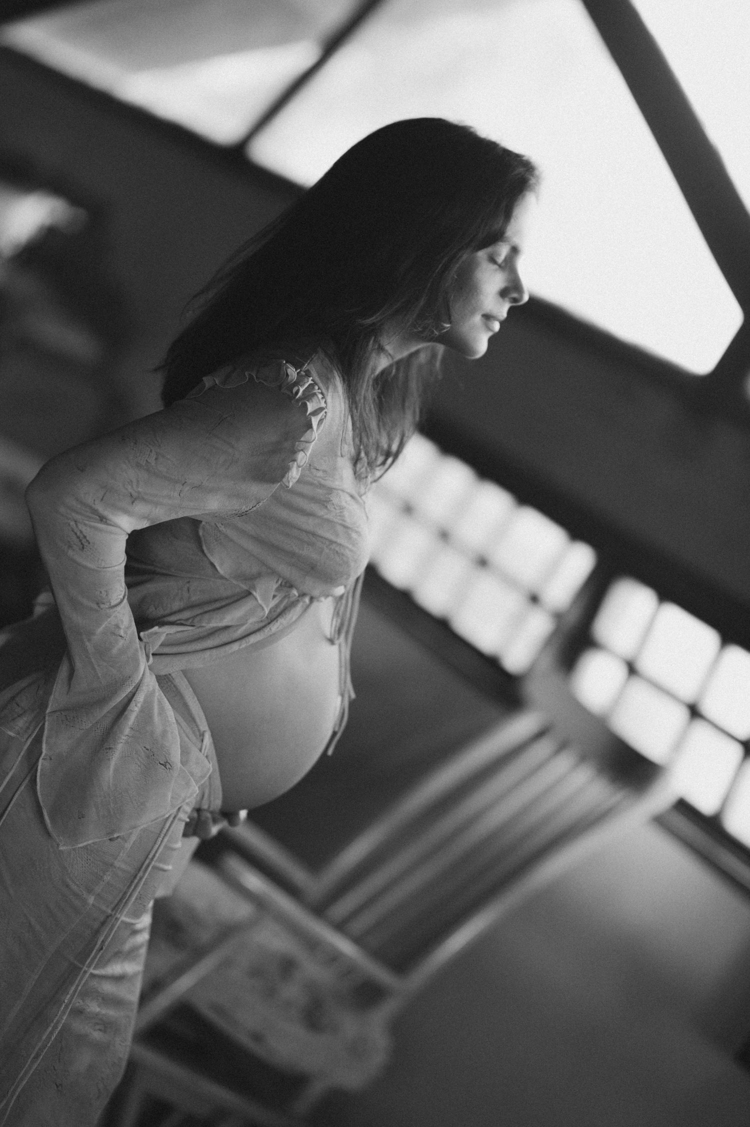 Black and white photo series showing a person in a white dress captured from different angles in an indoor setting.