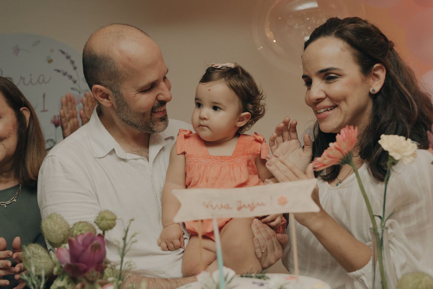 Celebration scene with flowers and decorations on a table.
