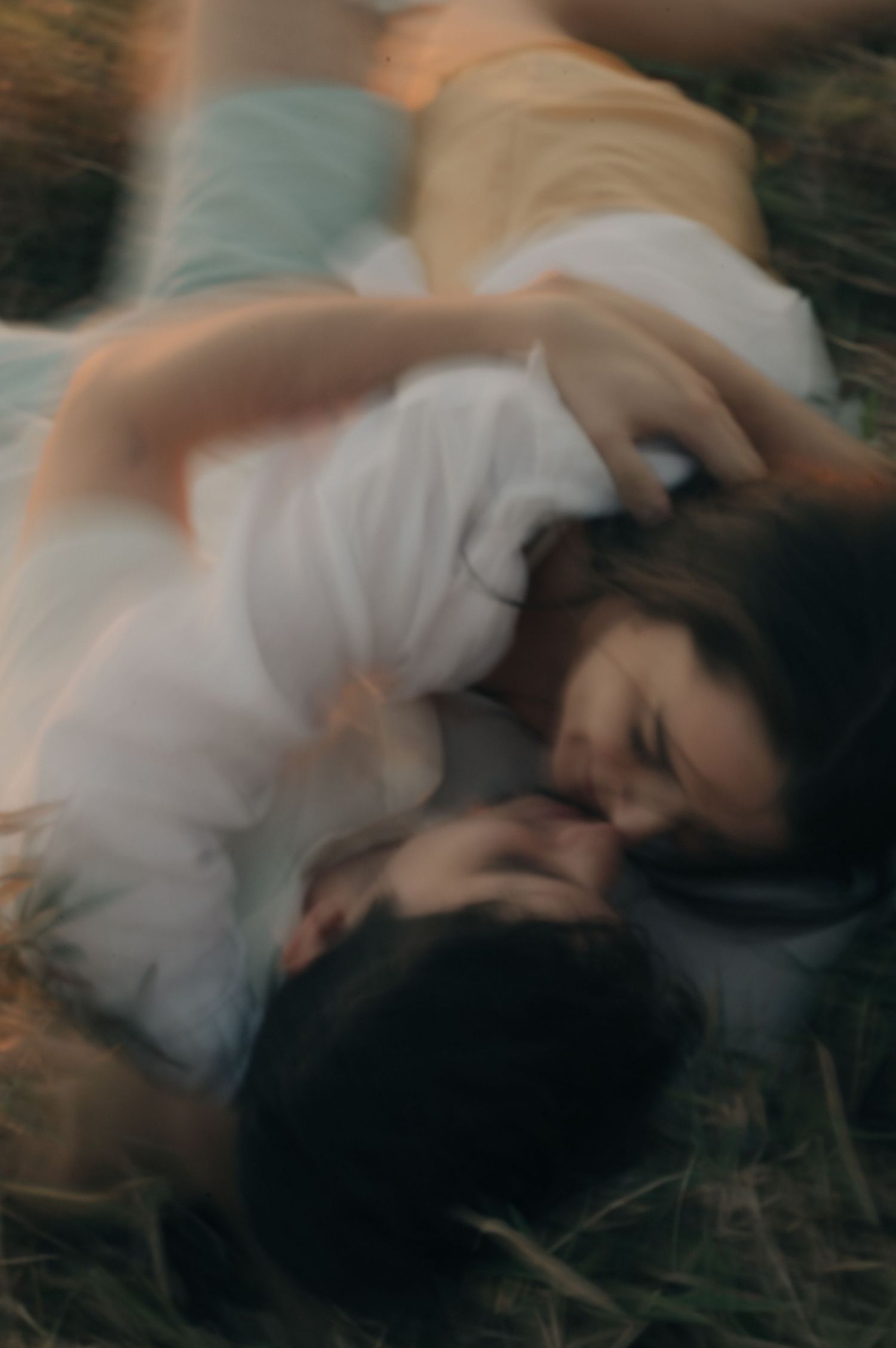 Artistic blurred photo of a couple sharing an intimate moment in nature.