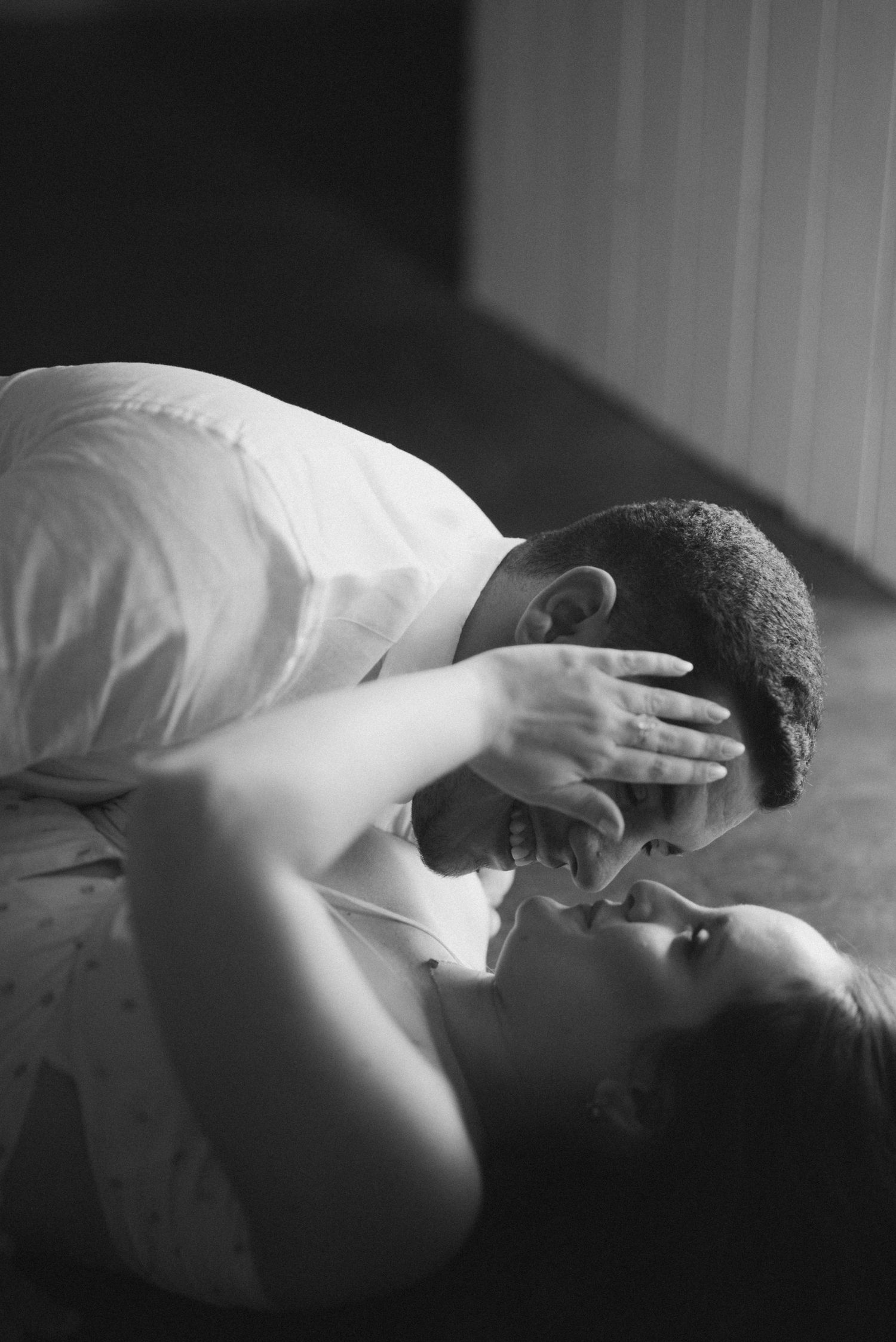 Intimate black and white portrait of a couple sharing a tender moment.