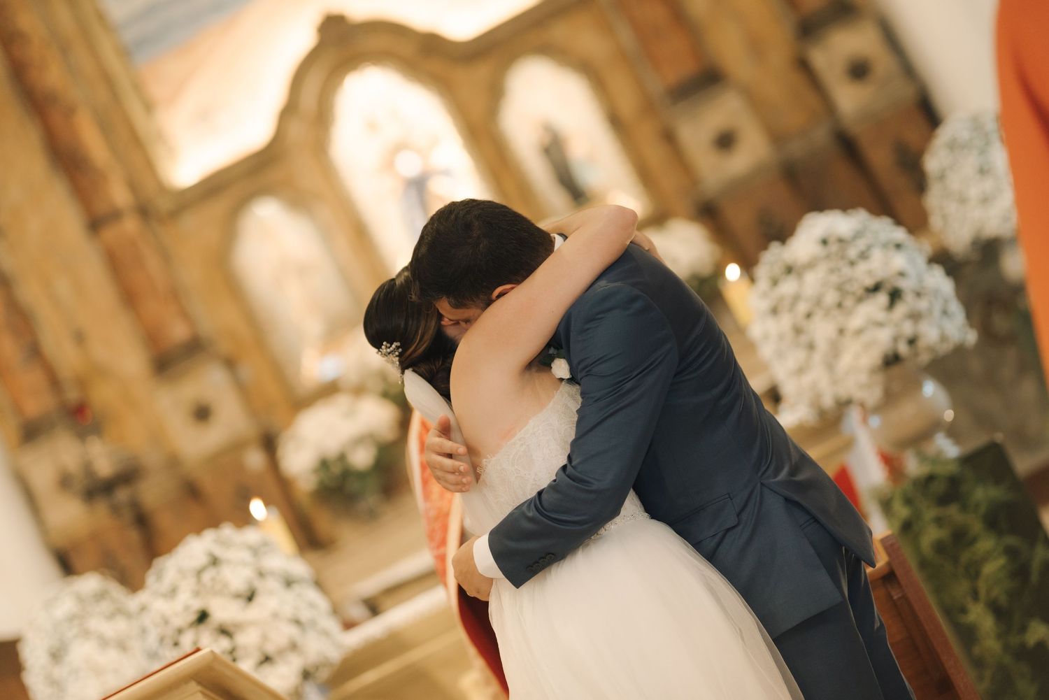 A romantic first dance between newlyweds in an ornate church setting.