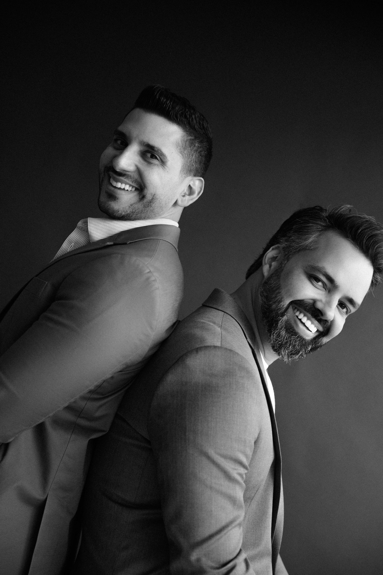 A dramatic black and white portrait series showing dynamic poses against a dark background.