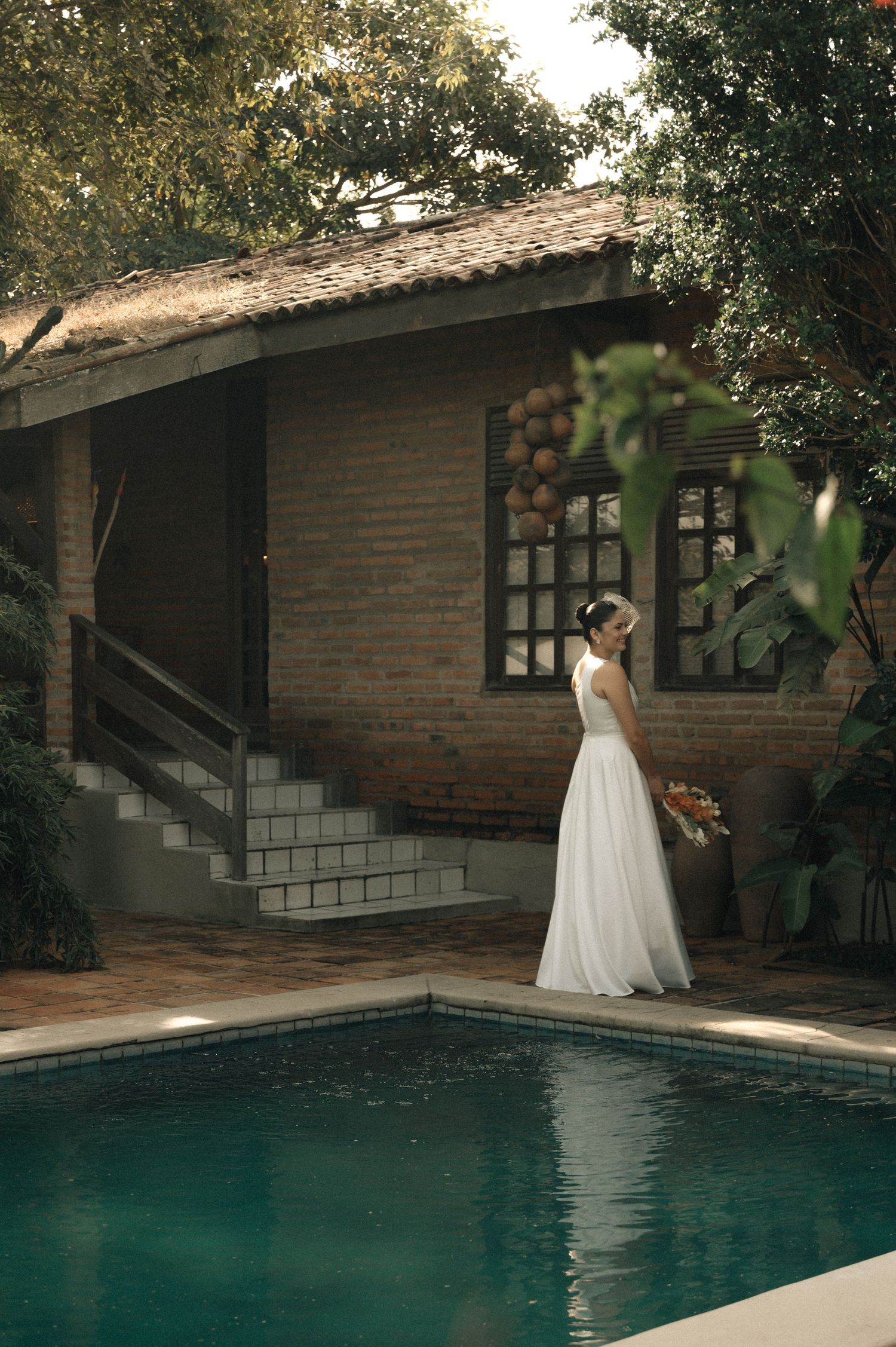 A series of artistic wedding photos showing a white dress against a swimming pool backdrop in warm tones.