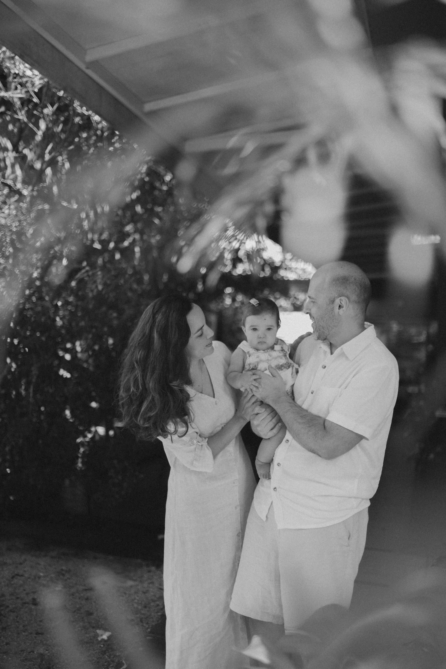 Family sharing a joyful moment together outdoors with sparkles in the background.