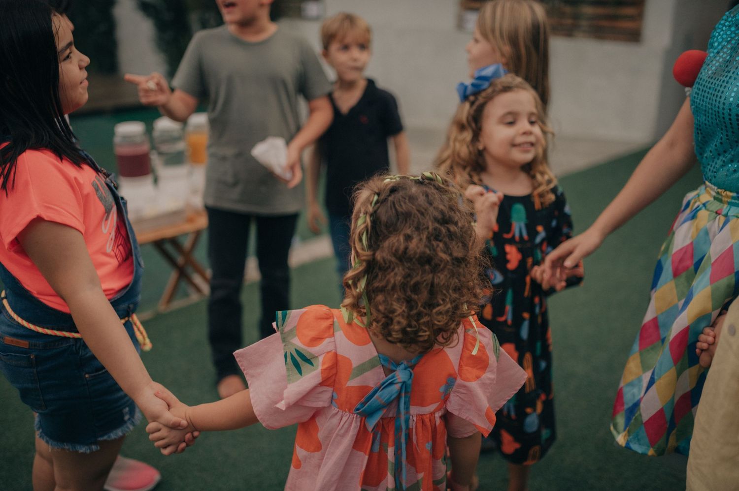 Children playing and dancing together at an indoor gathering.