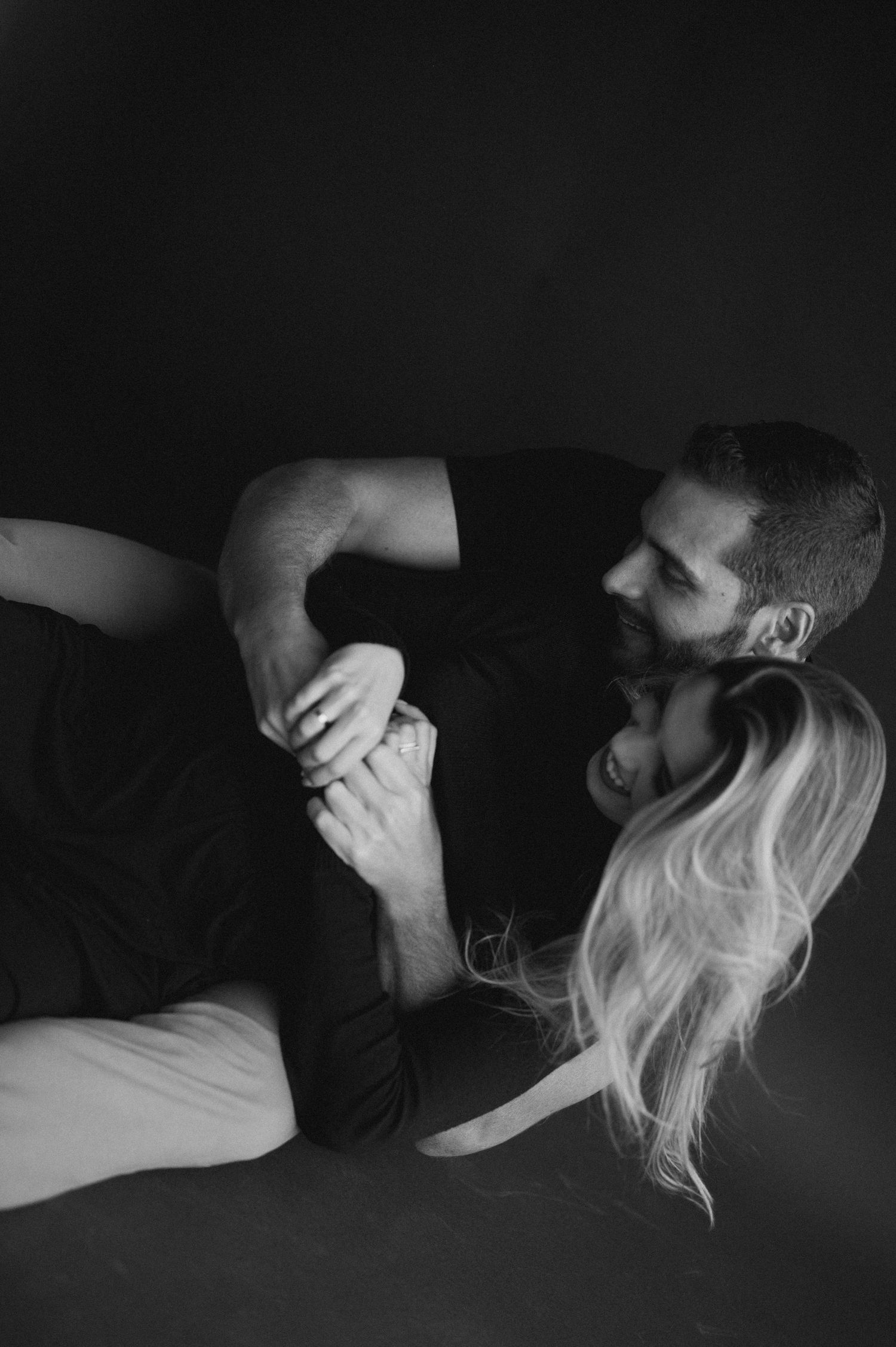An artistic black and white series of intimate close-up shots depicting passionate embraces in low-light conditions.