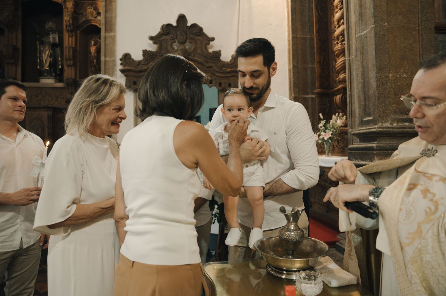 Wedding reception guests line up at a buffet table to serve themselves food at an elegant venue.